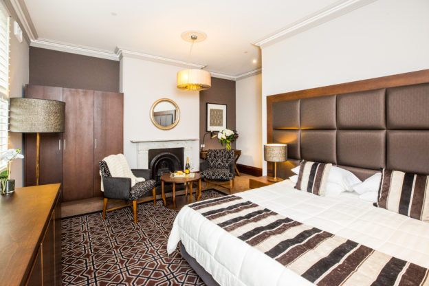 inside Avonmore on the Park's king suite which features a comfortable king size bed and luxury furnitures